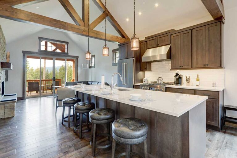 A homebuyer sits at a table reviewing mortgage documents and financial statements with a pen in hand.